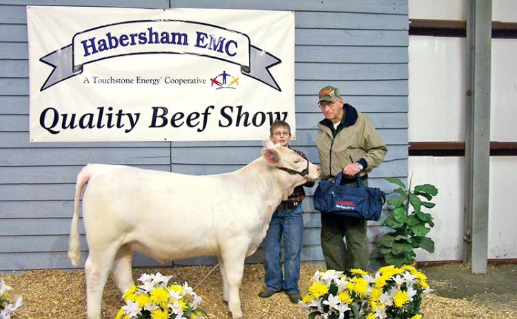 Barrett and one of his three grandchildren smile for a picture after the Habersham Electric Membership Corp. Quality Beef Show. Barrett was inducted into the 2019 Habersham County Farm Bureau Agriculture Hall of Fame Friday for his contributions to the agricultural community.