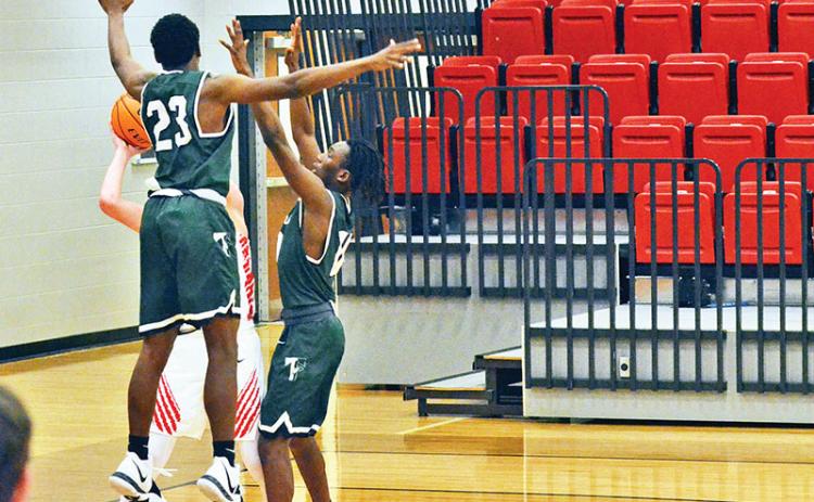 Rabun County’s Connor McKay is swarmed by Tallulah Falls defenders Devonte Allen (23) and Simeon Respress during Friday night’s game. The Indians turned the game around with a full-court press before falling late.