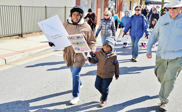Vanessa Burns and Langston Mayfield walk in Sunday’s Dr. Martin Luther King Jr. Peace Walk in Cornelia. Mayfield represented a strong contingent of children who participated in the event.