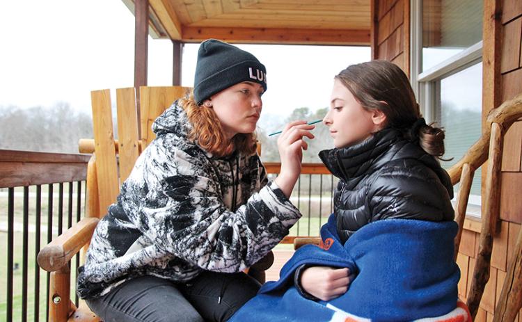 Megan Hoffman does some final touch ups for Sofia Xavier playing the role of Esther at the filming site in Mt. Airy for the independent student film “Homestead.”