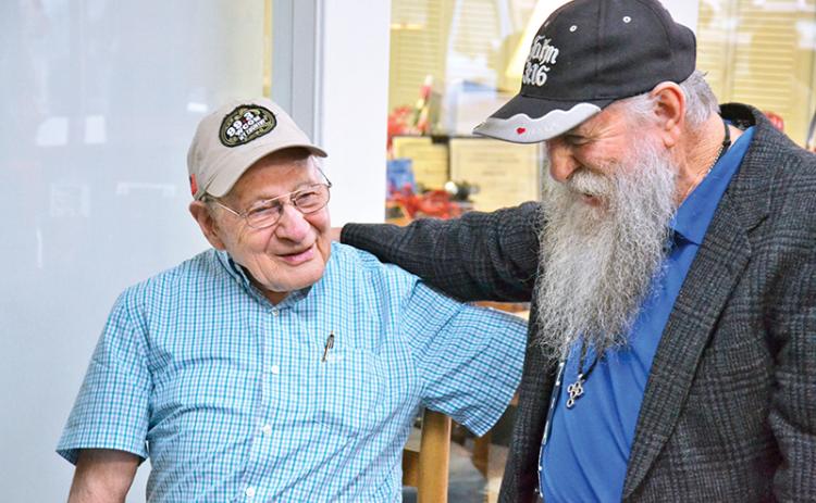 Billy Burrell (left) shares a laugh with John A. Harris at his birthday party on Friday morning.