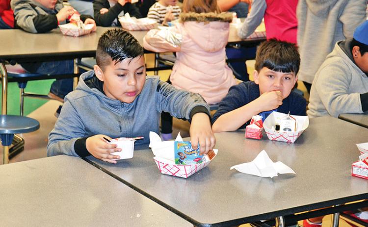 Level Grove Elementary students Christopher Negrete and Jonah Edmonds enjoy their breakfast Thursday morning before starting the school day. All students in Habersham County receive free breakfast before school in the morning.