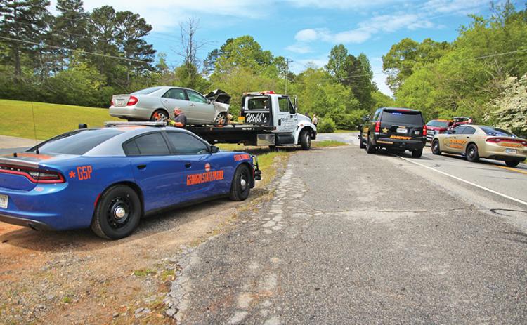 A two-car crash Sunday put four people in the hospital after an alleged failure to yield at a stop sign.