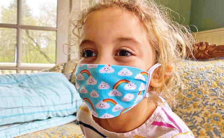 Ruby Benton poses with one of the homemade masks.
