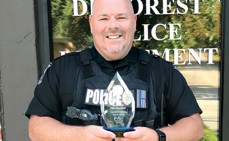 Former Demorest Police Chief Robin Krockum shows off the department’s award for best highway safety in the state in 2018-19.