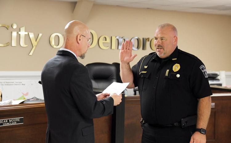 Demorest Police Chief Robin Krockum was sworn in by Mayor Rick Austin again at the Tuesday Demorest meeting following three weeks of confusion when he was terminated by City Manager Kim Simonds April 16.