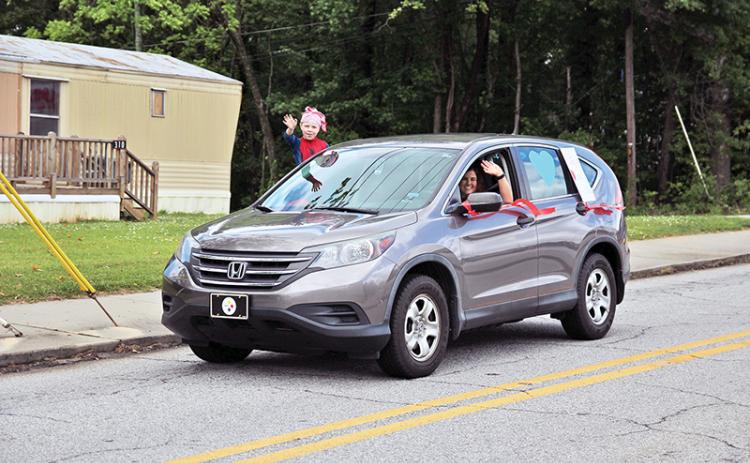 Cornelia Elementary School teachers along with Habersham County public safety personnel drove through the streets of Cornelia to wish them a happy and safe summer on Thursday.  Principal Amy McCurdy said more than 50 vehicles were estimated to have participated. Photos by ERIC PEREIRA/Staff