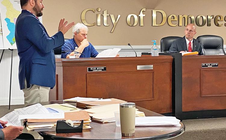 Cornelia Mayor John Borrow (left) makes a presentation Tuesday to the Demorest City Council, including Councilman Sean Moore (seated middle) and Mayor Rick Austin. Photo by ERIC PEREIRA