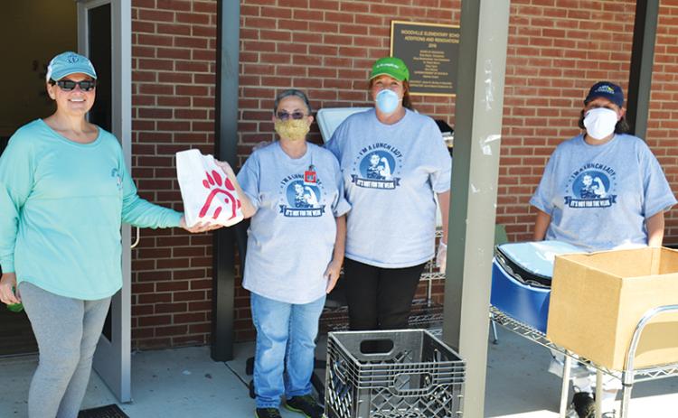 Stephanie Walker, transportation director for Habersham County Schools, delivers Chick-fil-A lunches to Woodville Elementary’s nutrition crew Friday including Jackie Cane, manager Liz Martin and Mary Beth Justice of the Ninth Grade Academy.