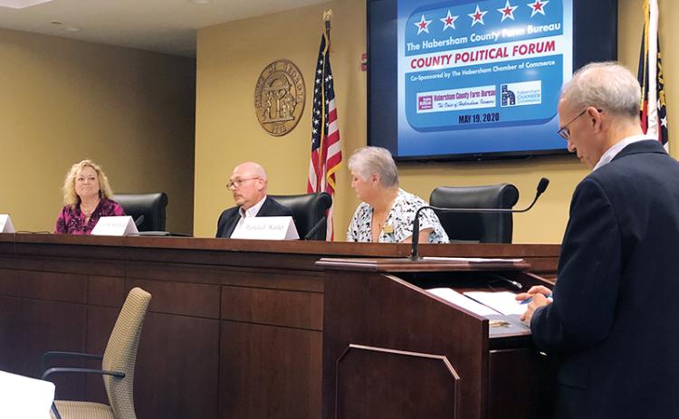 Candidates for probate judge (from left) Cindy Freeman, John Whitfield and Pam Wooley discuss the issues Tuesday night with moderator Joel Williams of WCON Radio. Photo courtesy of Farm Bureau