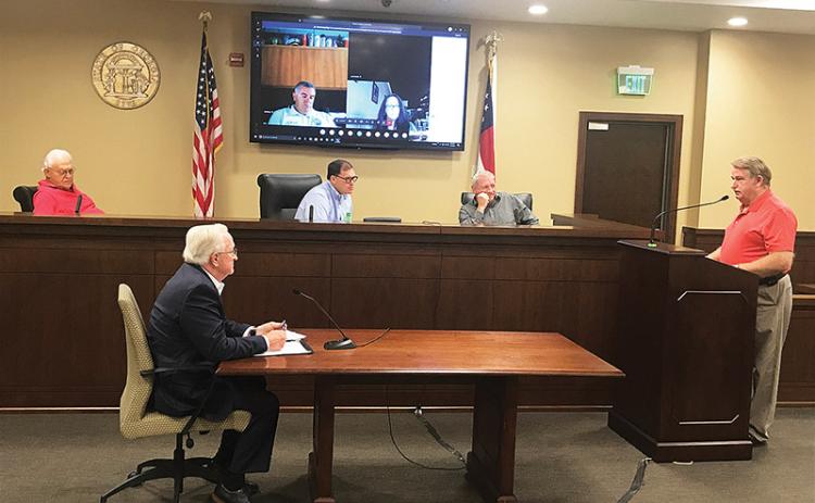 County Manager Phil Sutton (bottom left) along with Commissioners Jimmy Tench, Stacy Hall and Tim Stamey (from left on bench) listen to Banks County Fire Chief Steve Nichols discuss radio systems on Monday morning.