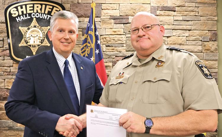 Lt. Brian McNair of the Hall County Sheriff’s Office gets his promotion from Sheriff Gerald Couch in the fall of 2019. McNair, a Clarkesville resident, died Monday from complications related to COVID-19.