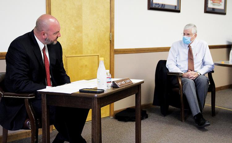 Superintendent Matthew Cooper and Board of Education member John Elger debate the issue of school reopening at Monday’s Board of Education meeting.