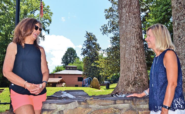 Recently retired Demorest Elementary teachers Allison Roland (left) and Mary McDuffie chat at Demorest Springs Park on Monday. The two put in 30 years each teaching Habersham County students, 19 of those together at Demorest.