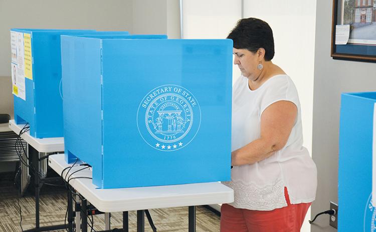 Beth Palmer of Clarkesville casts her vote Thursday at the Habersham County administration building. Early voting ended Friday and the runoff election is Tuesday, Aug. 11.
