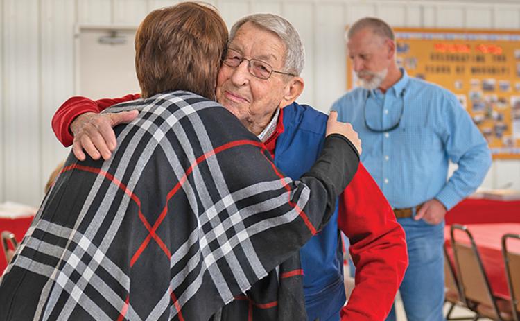 Lewis Canup embraces his granddaughter Kelli Mayes at his 90th birthday party. Canup retired in 2015 after working as the Habersham County Administrator/Manager and Engineer.