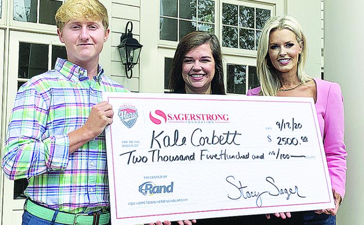 Kale Corbett  receives a check for $2,500 scholarship in addition to being named the 2020 SagerStrong Foundation Hometown Hero. To Corbett’s right are Randi Minor, Principal at Rand Refrigeration and Stacey Sager, President of the SagerStrong Foundation.