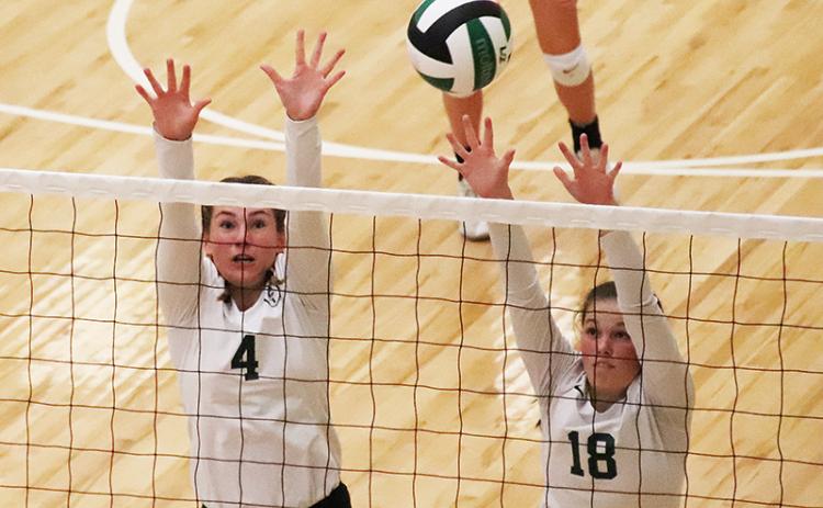 Tallulah Falls’ Abby Carlan (4) and Sarah Jennings elevate for the block during a recent match. BRIAN CARTER/Special