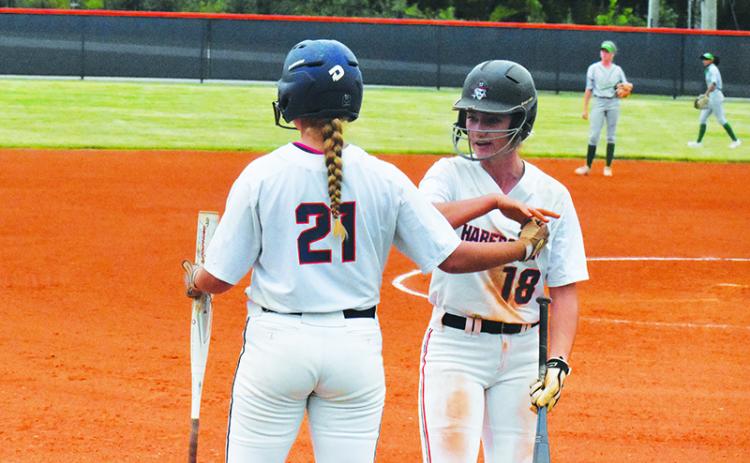 Habersham Central’s Taylor Wade and Preslee Hix celebrate a run against Buford on Sept. 16. CODY ROGERS/Staff
