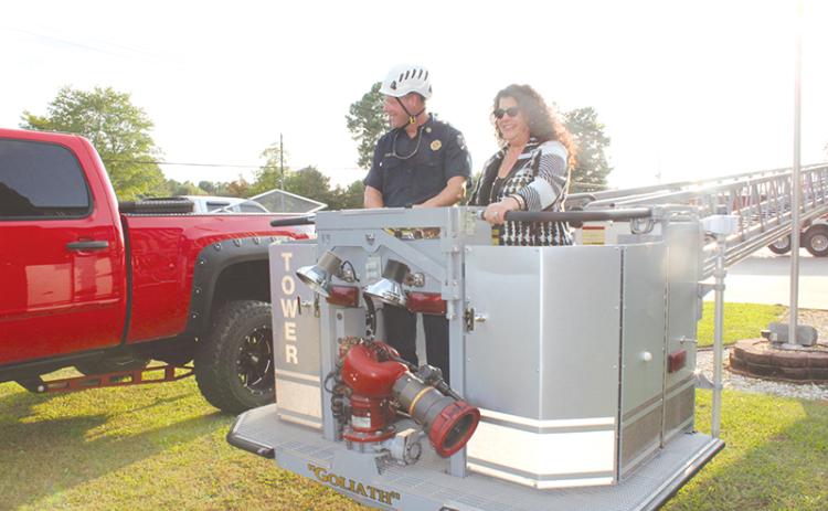 Councilwoman Stephanie Almagno and Fire Chief Joe Roy prepare to take in Baldwin’s aerial view from the basket of one of the new trucks before Monday’s meeting.