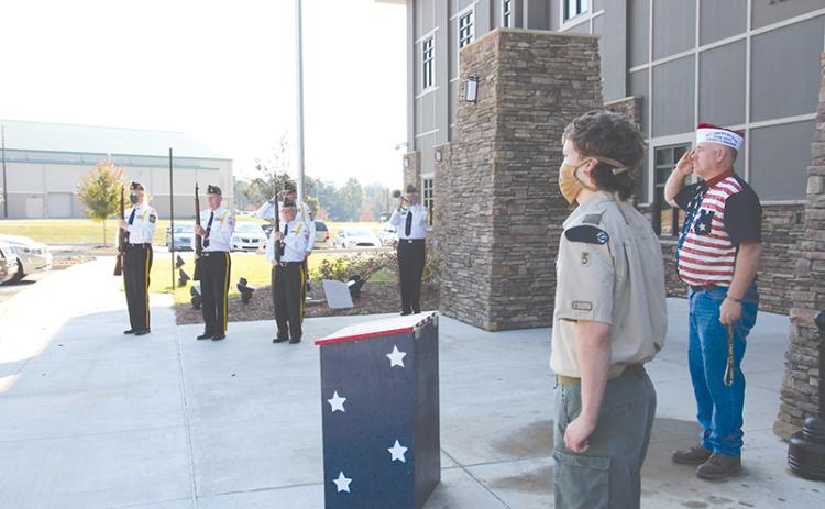 Grant Reeves VFW Post 7720 Commander Bill Miles (right) and Eagle Scout Joseph McNair stand at attention while the VFW Honor Guard plays “Taps” at Tuesday’s dedication ceremony for the flag retirement boxes.