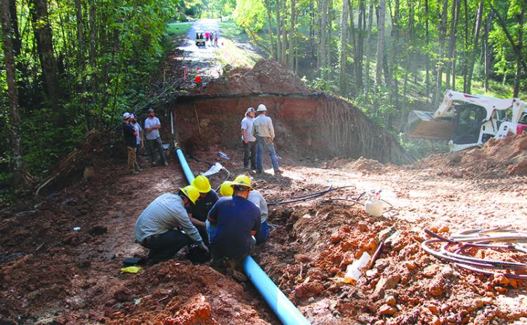 Habersham EMC and Demorest Water Department crews work together to restore power and water on Laurel Oak Drive. Photo by ERIC PEREIRA