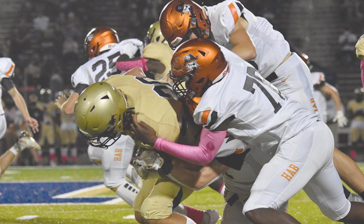 Habersham Central’s Alex Aaron leads a tackle of a Dacula ballcarrier during Friday’s game. LILLIAN VANTASSEL/Special