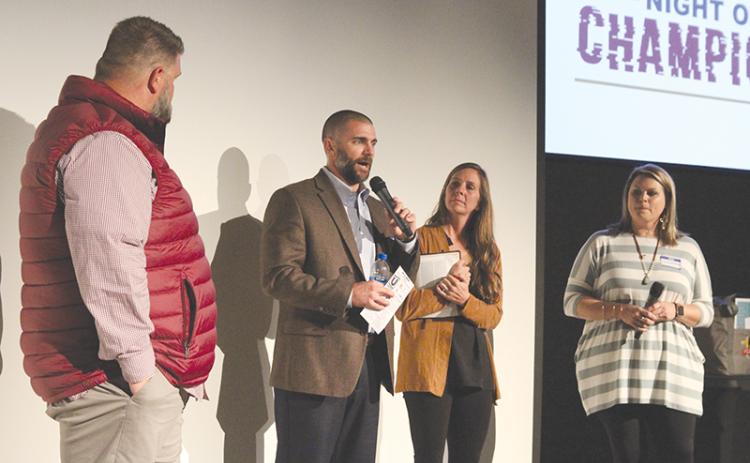 FCA area representative Thomas Burnett, left, and his wife Samantha Burnett (far right) ask questions to FCA Leadership Board members Chris and April Akridge. Photo by ERIC PEREIRA/Staff