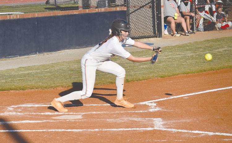 Taylor Wade lays down a bunt for a hit Monday’s win over Winder-Barrow. Wade reached base four times and scored three runs for the Lady Raiders.
