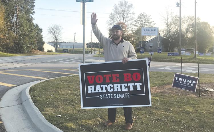 Georgia Senator-elect Bo Hatchett waves to cars Tuesday morning on Louise Street and Jacob’s Way near the Ruby Fulbright Aquatic Center.