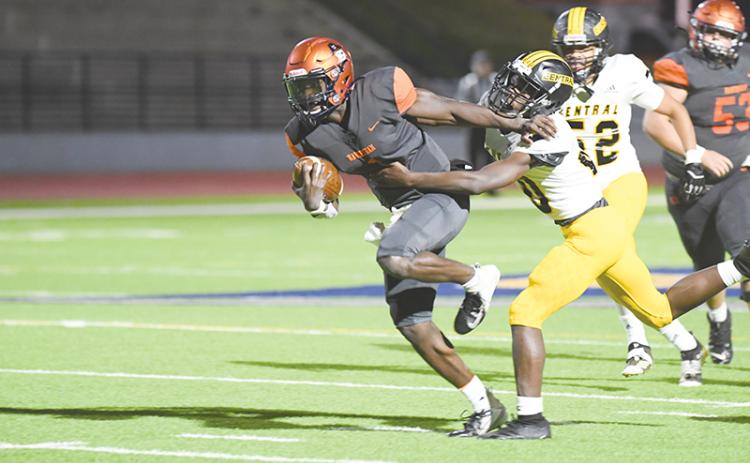Habersham Central’s Joshua Pickett does a Heisman stiffarm to bypass a Central  Gwinnett tackler on Tuesday night. TOM ASKEW/Special