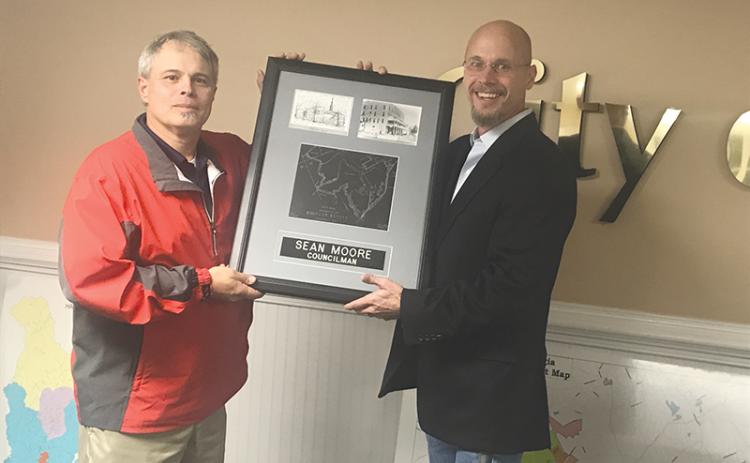 Demorest Mayor Rick Austin (right) presented departing Councilman Sean Moore with a plaque commemorating his service at Tuesday’s City Council meeting.