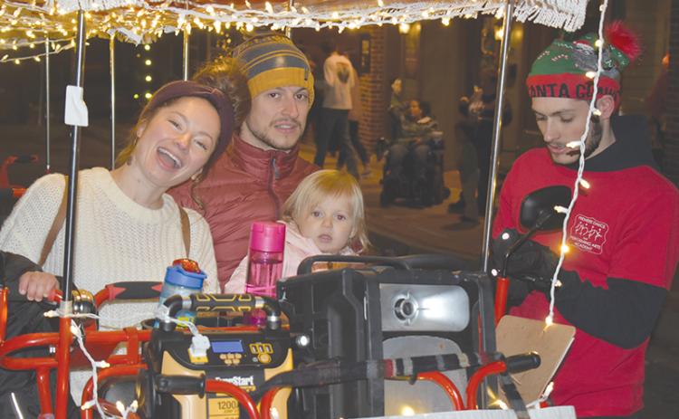 Jessica and Chris Gneiding took their little ones Anneliese (shown) and Lucas on the pedal cart at the Downtown Christmas event in Cornelia on Saturday.