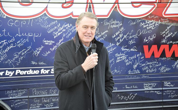 U.S. Sen. David Perdue chats with folks in Cornelia on his bus tour of Georgia leading up to the runoff election on Jan. 5.