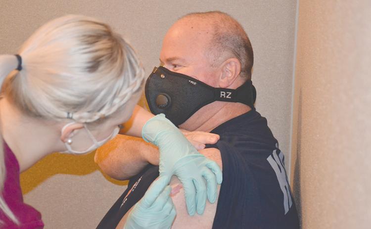 Habersham Emergency Services paramedic Greg Ramey gets his COVID-19 vaccine Wednesday from nurse Lauren Martin at Habersham Medical Center.