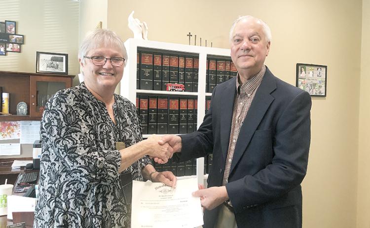 School board member Joey Duncan (right) is sworn in Monday morning by Judge Pam Wooley.