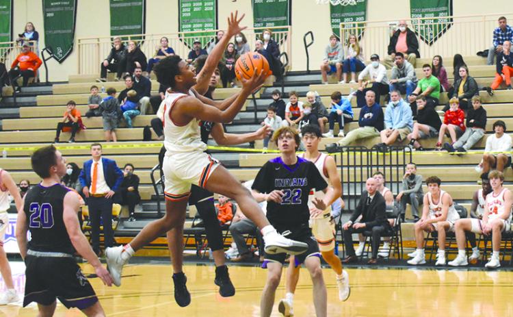 Malachi Dooley looks to finish over a defender in the Raiders’ season-opener against Lumpkin County. Dooley led HCHS Tuesday night with 31 points in the double-overtime victory that got the Raiders off to their first 4-1 start since 2011-12.