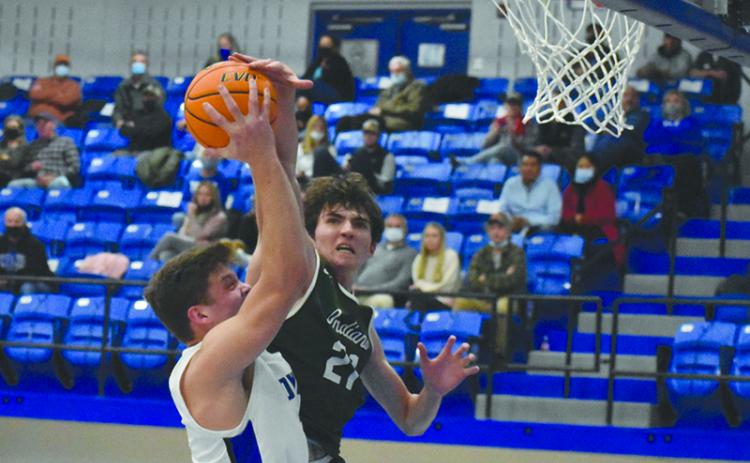 Tallulah Falls’ Gabe Keene challenges Towns County big man Jake McTaggart at the rim during their game Dec. 3.