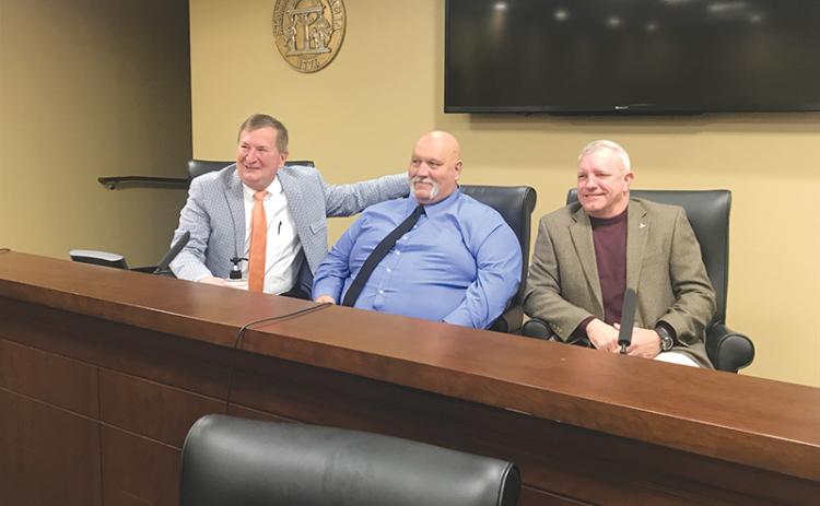 Newly-sworn in Habersham County Commissioners (from left) Bruce Harkness, Bruce Palmer and Tim Stamey visit briefly after signing their paperwork to begin their four-year terms.