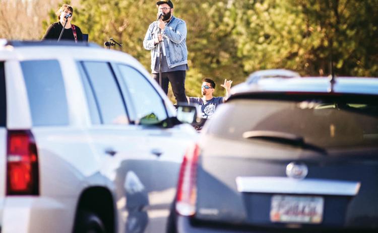Eric and Misty Wilcox sing at The Torch’s drive-up prayer service March 22 at one of the first socially-distanced worship services during the COVID-19 crisis.