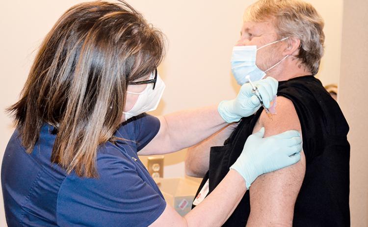 Dee Dillin, the imaging services director at Habersham Medical Center, is the first person in Habersham County to get the vaccine Wednesday, administered by nurse Kim Albertson.