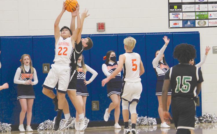 Brody Bantaum skies for a rebound in the seventh grade championship game. The Raiders knocked off Franklin County 43-36 to win the title.
