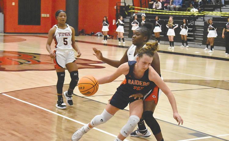 Habersham  Central’s Taylor Wade drives inside against a Stephens County defender during Tuesday night’s game in Toccoa.