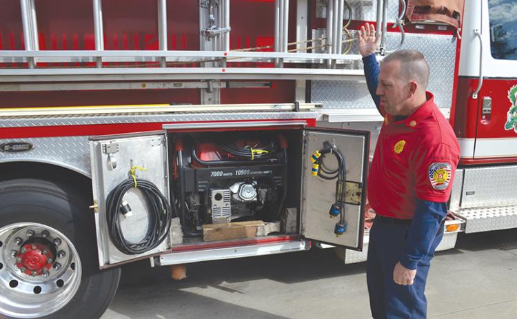 Demorest Fire Chief Ken Ranalli explains the process his staff has to go through to get additional lighting at an emergency scene, including pulling a generator stored in the department’s pump truck. The truck has been in service in Demorest for 25 years.