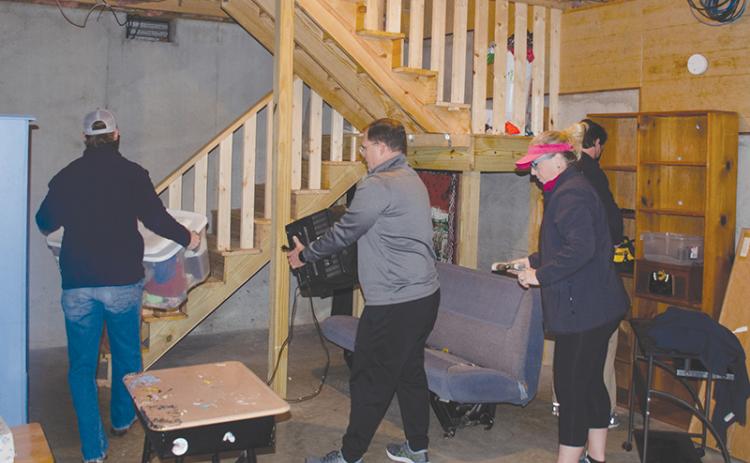 Local nonprofit The Everyday Good is currently working with a local family to finish a basement to expand sleeping, learning and work space. Shown, from left, are Ken Johnson, and Stacy and Ivy Hall.