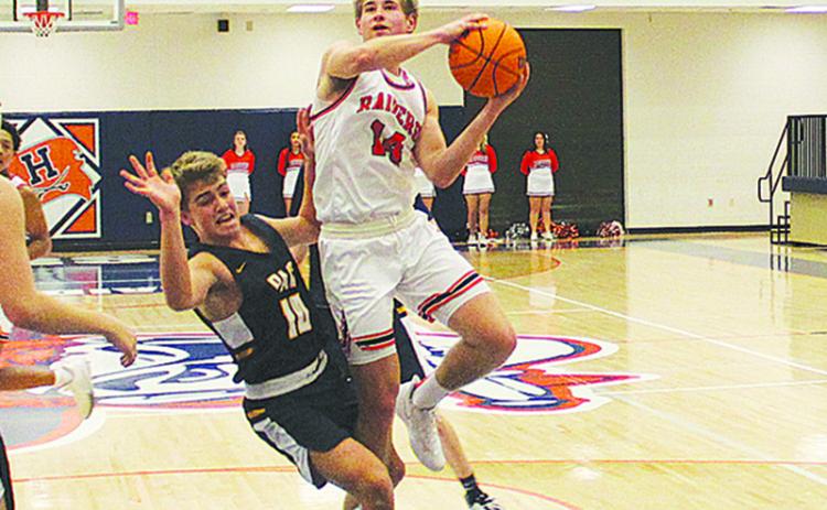 Senior guard Grant Tipton finishes through contact during a game against Prince Avenue earlier this season.