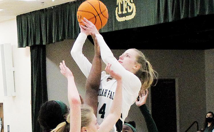 Macy Murdock finishes a layup over three Lady Wolves defenders.  Murdock will be one of the returning players looked to for leadership next season with the Lady Indians losing three senior starters.