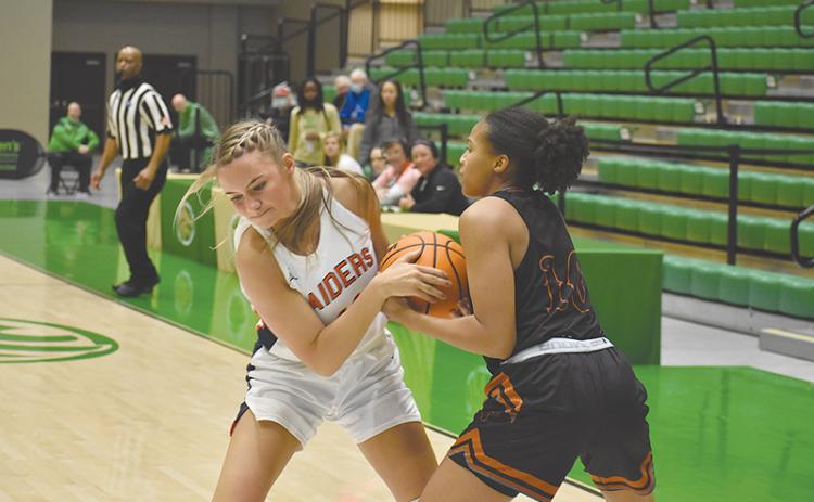 Habersham Central’s Hailey Wade (left) battles Lanier’s Kiara Johnson for possession during Friday’s regional semifinal.