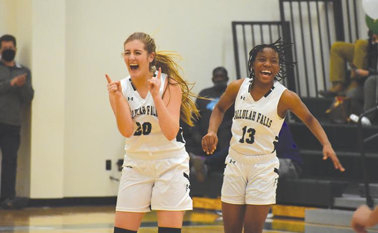 Tallulah Falls’ Katy Corbett celebrates with teammate Veronaye Charlton during the second half of Friday’s game. Corbett hit 10 3-pointers to set a school record.