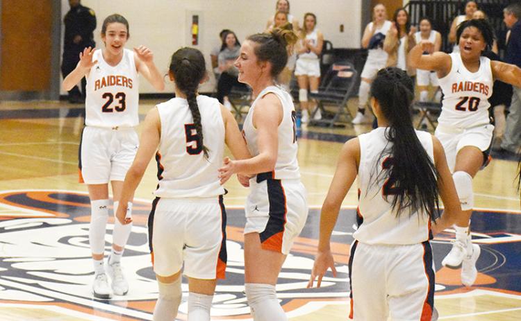 Habersham Central's girls basketball players (from left) Kyia Barrett, Addie Penick (5),  Taylor Wade, Liz Pollitt and Nyke Brown celebrate a 3-pointer by Penick in the opening round of the state playoffs. Penick was fouled and went on to convert a four-point play.